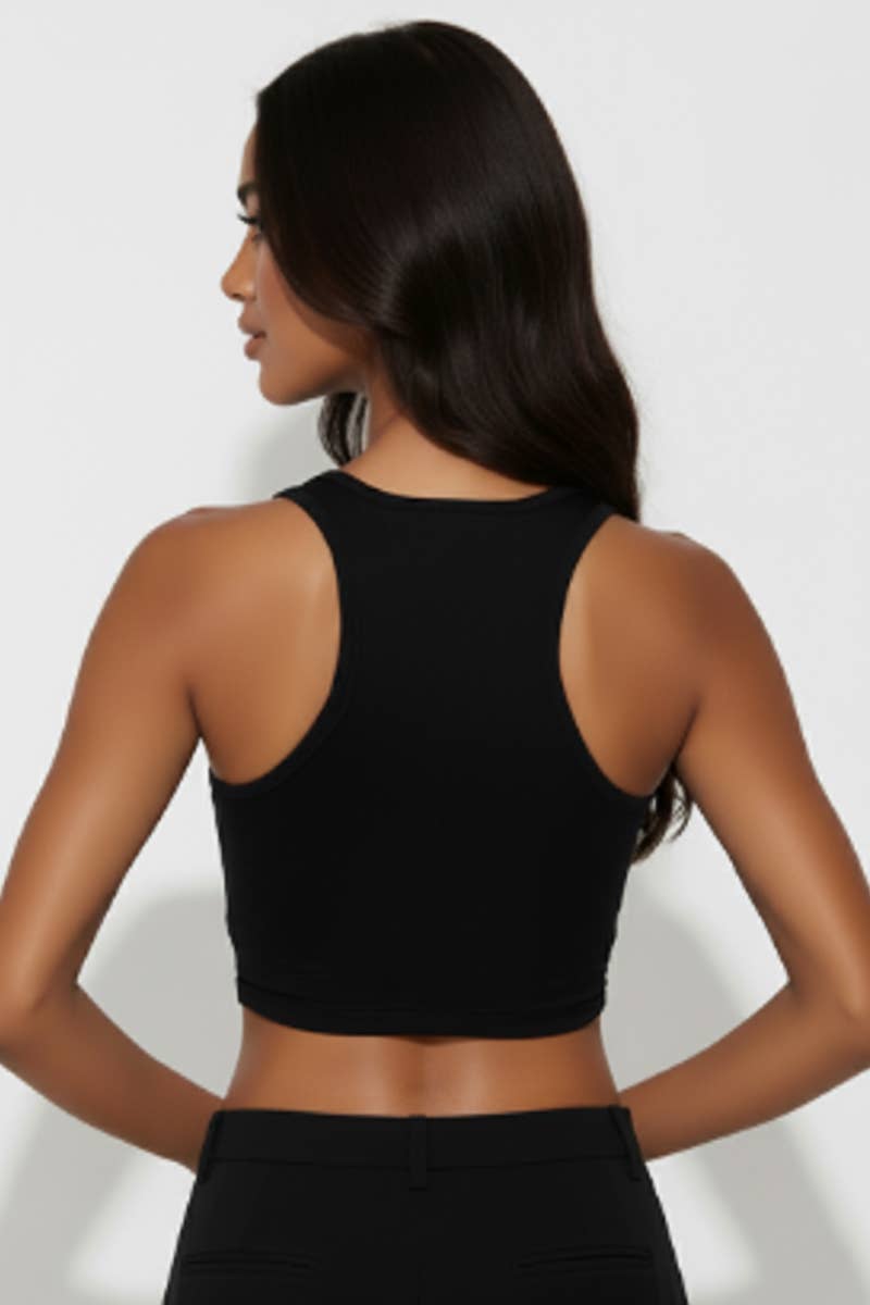 Woman wearing a black sleeveless top against a white background