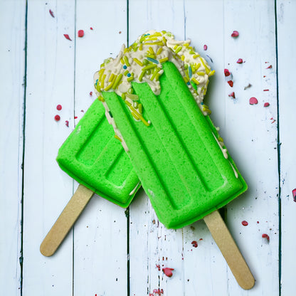 Two popsicle bath bomb - green against a wooden background