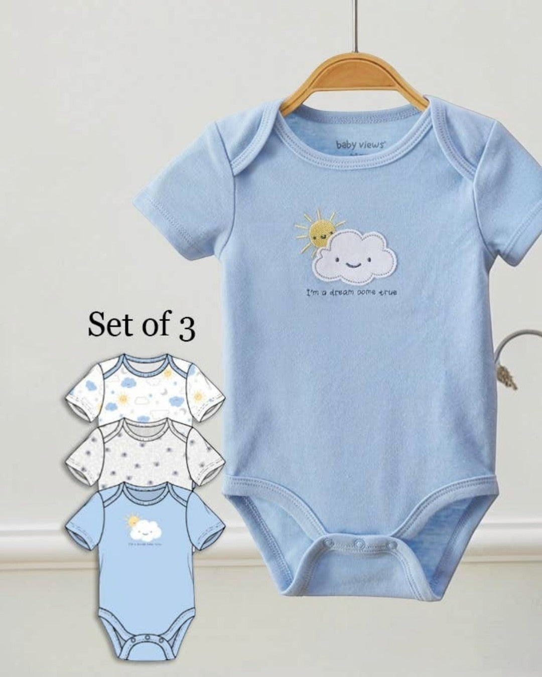 Set of three baby bodysuits with cloud and sun design on a white background