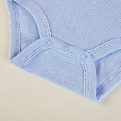 Close-up of a light blue baby bodysuit on a beige background