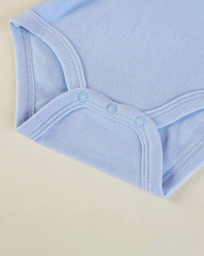 Close-up of a light blue baby bodysuit on a beige background