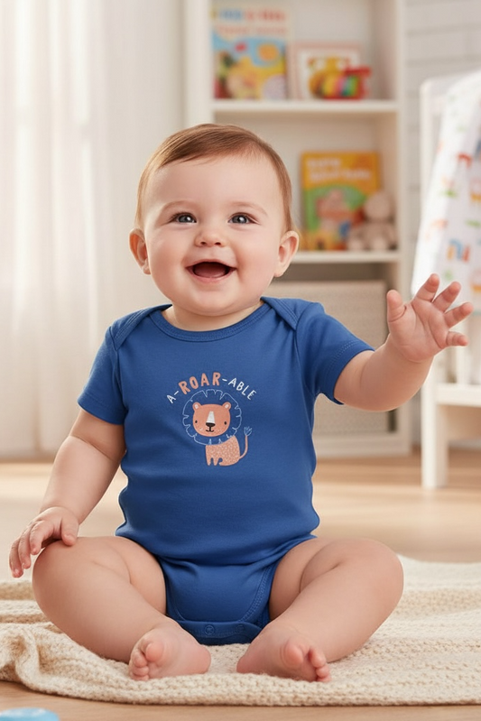 Baby wearing a blue onesie with a lion graphic and 'Roar-able' text, sitting on a rug in a room with toys and books.