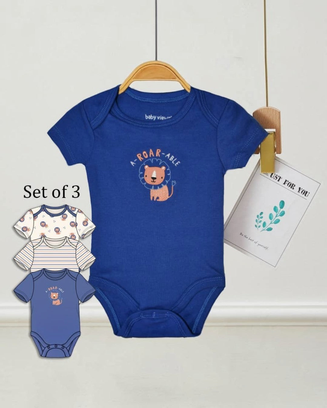 Blue baby bodysuit with lion design on a hanger, set of three shown below.