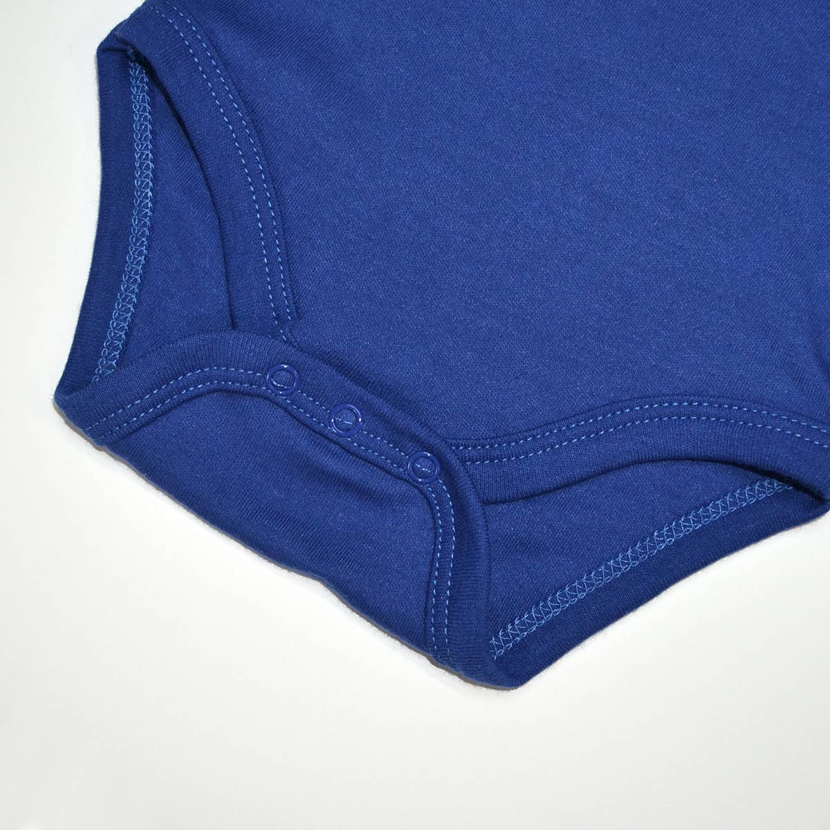 Close-up of a blue baby onesie on a white background