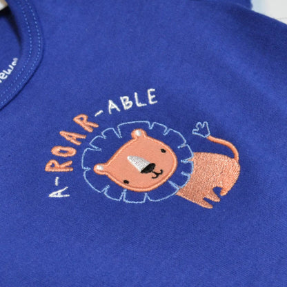 Embroidered lion design on a blue fabric with 'ROAR-ABLE' text.