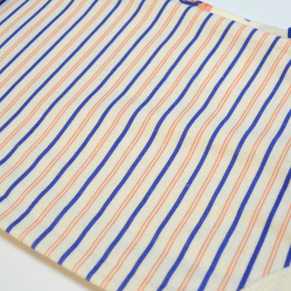 Close-up of fabric with blue and orange stripes on a white background