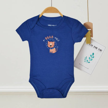Blue baby onesie with a lion graphic and text on a hanger against a white wall.