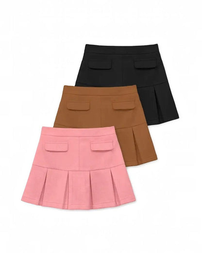 Three pleated skirts in black, brown, and pink on a white background