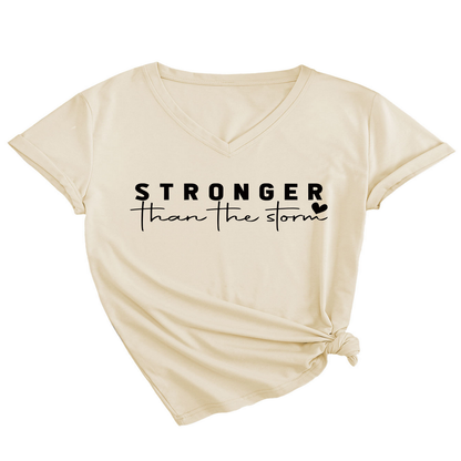 Beige t-shirt with 'Stronger than the storm' text on a white background