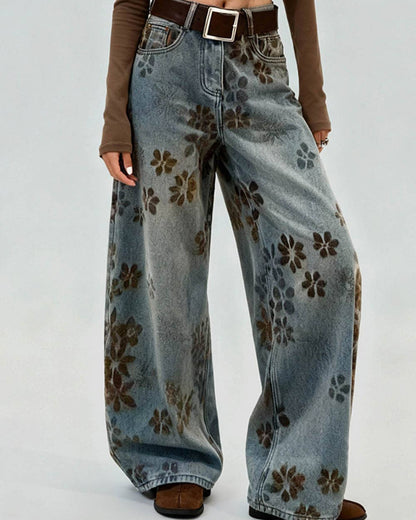Floral-patterned jeans worn by a person on a white background