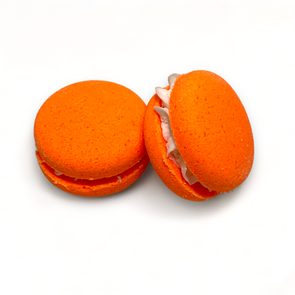 Two orange milo monkey bath cookies against a white background