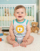 Baby romper with lion graphic and text on a white background