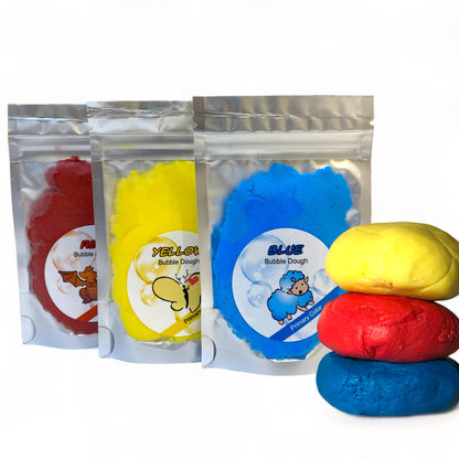 Our single packs of red yellow and blue bubble dough with lumps of them outside of the packs all against a white background