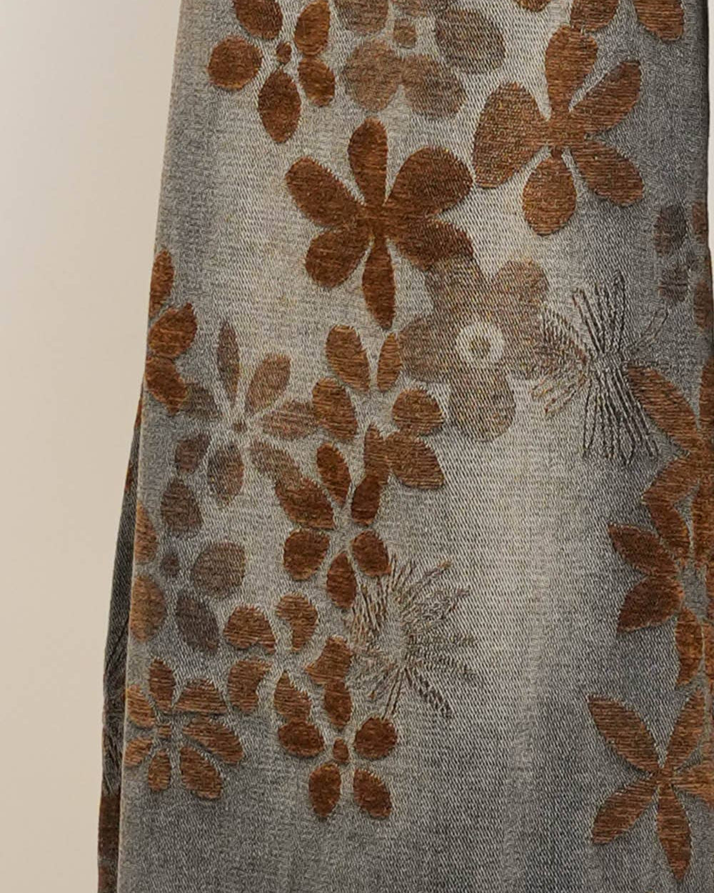 Textile with brown floral patterns on a gray background