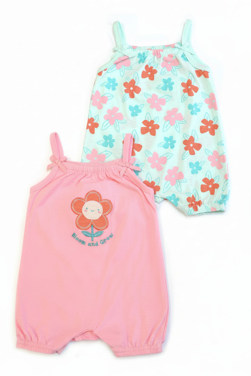 Two baby rompers, one pink with a flower design and the other floral patterned, on a white background.