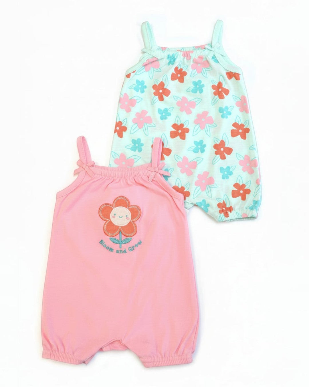 Two baby rompers, one pink with a flower design and the other floral patterned, on a white background.