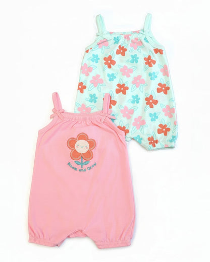 Two baby rompers, one pink with a flower design and the other floral patterned, on a white background.