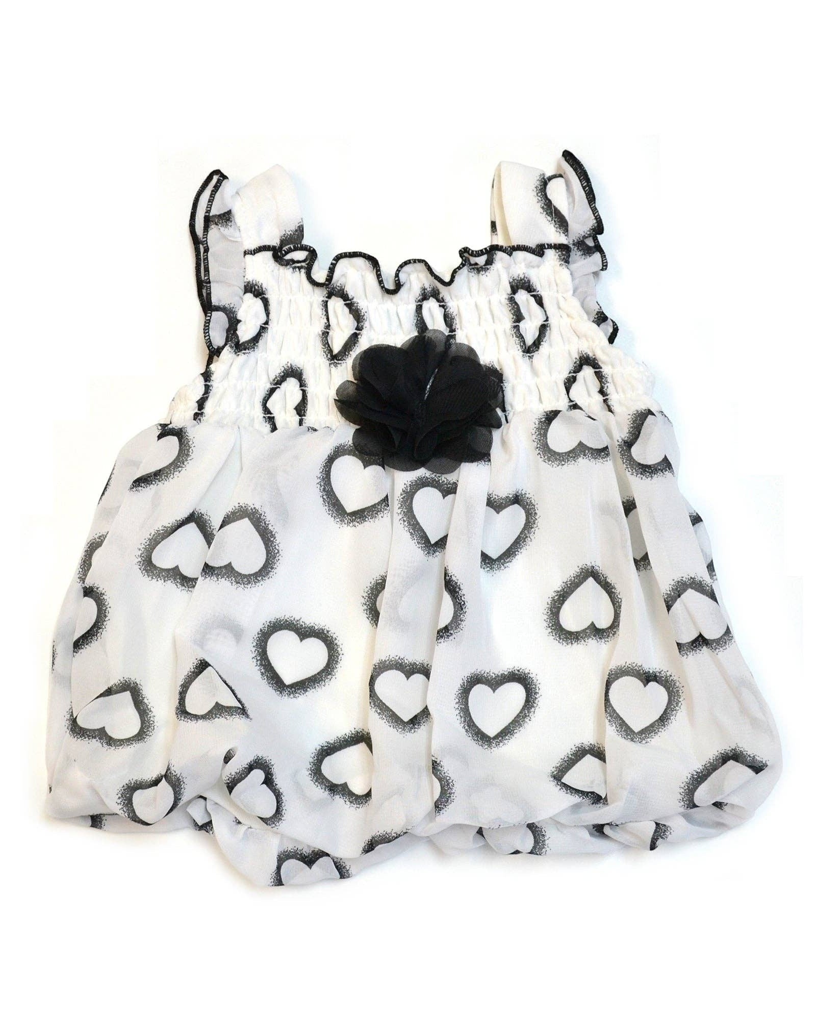 White drawstring bag with black heart patterns on a white background