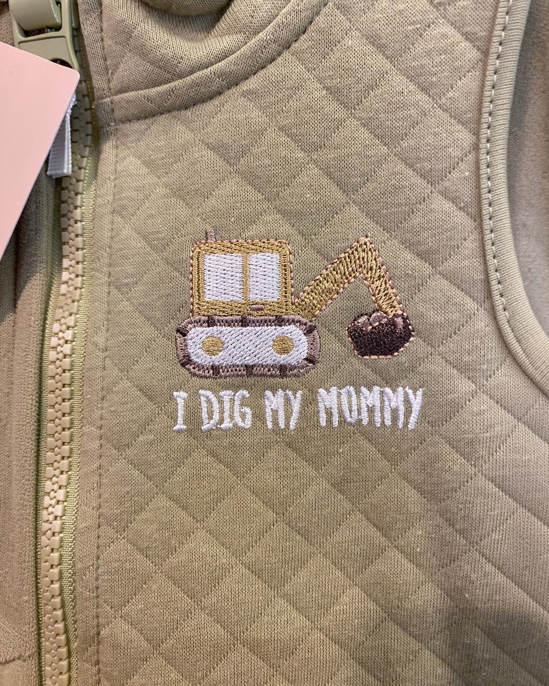 Khaki fabric with embroidered design and text 'I Dig My Mommy'