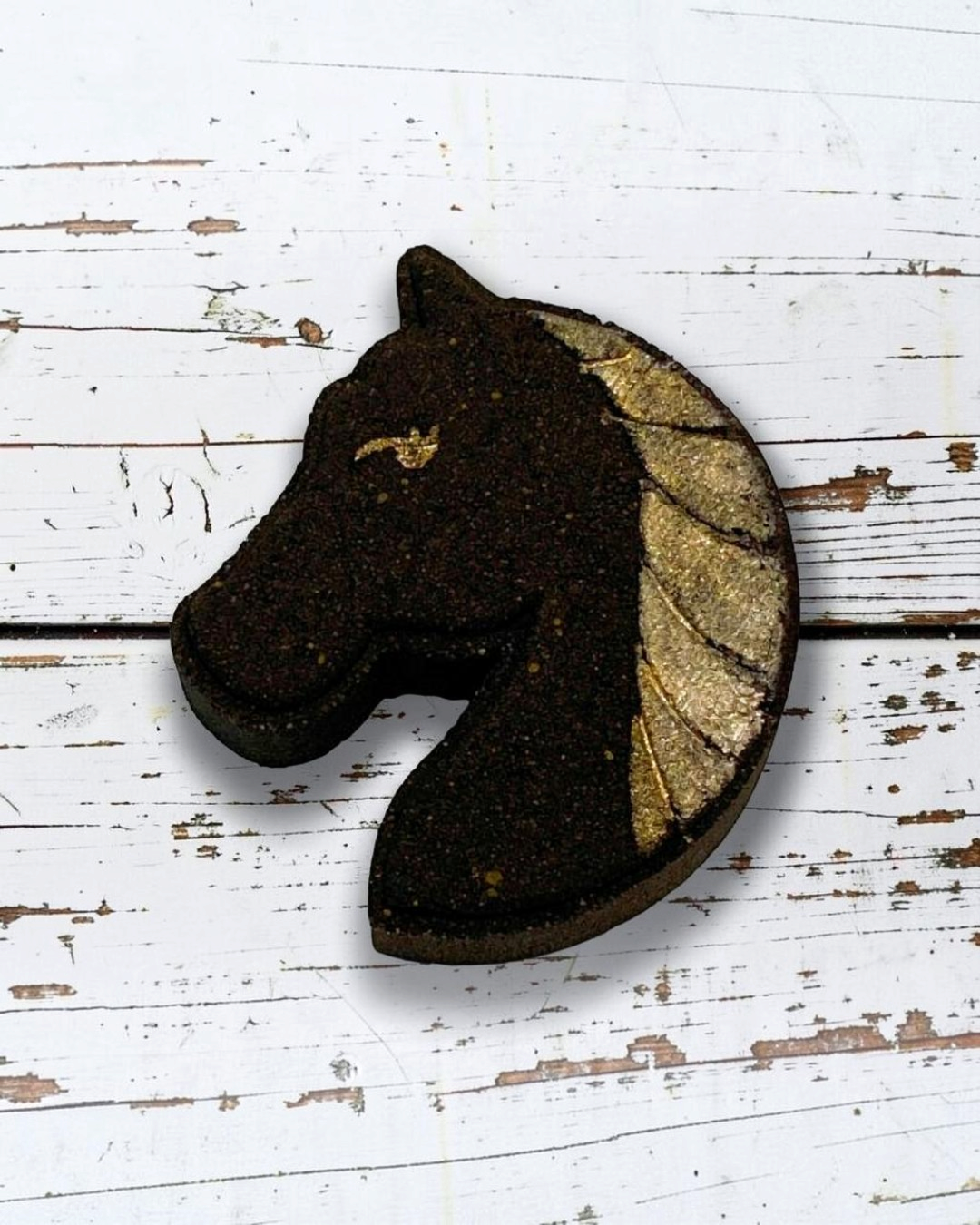 Calla Lily Cosmetics + CL kids horse-shaped bath bomb with dark brown body and shimmering gold mane detail.