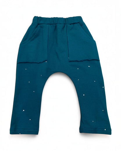 Teal baby pants with star patterns on a white background