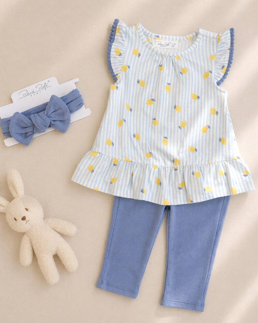 Children's outfit with top, pants, and headband on a beige background