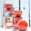 A stack and tube of red orange tigers blood bath cookies against a wood background