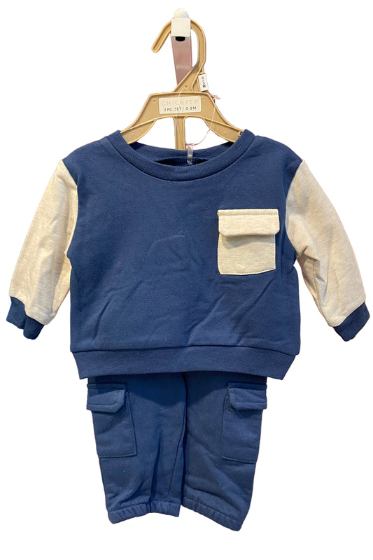 Blue sleeveless top with beige accents on a hanger 