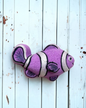 Calla Lily Cosmetics + CL kids purple clown fish bath bomb with glittery accents on a white wooden background