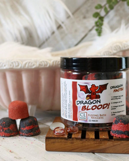 A container of gumdrop shaped red and black "dragons blood" bath bombs with a tiny 3 bath bomb pyramid to its side