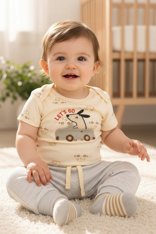 Baby outfit set with bodysuit, pants, and socks on a light background