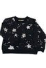 Black sweater with white star patterns on a white background