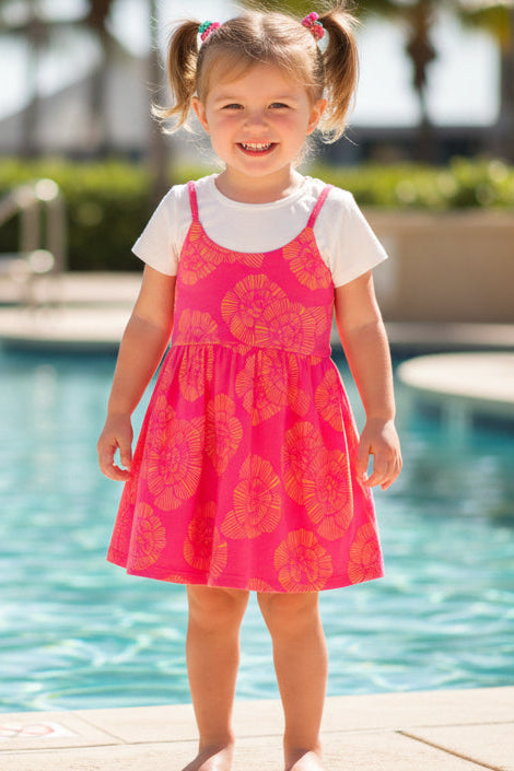 Pink dress with yellow floral pattern on a white background