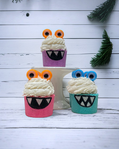 Calla Lily Cosmetics + CL kids monster bath bombs in purple, pink, and teal with bubble icing and googly eyes