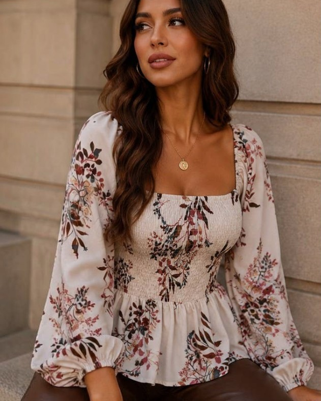 A woman modeling a floral long-sleeve peplum blouse in multiple panels, paired with brown pants, shown both close-up and full-length in an outdoor architectural setting.