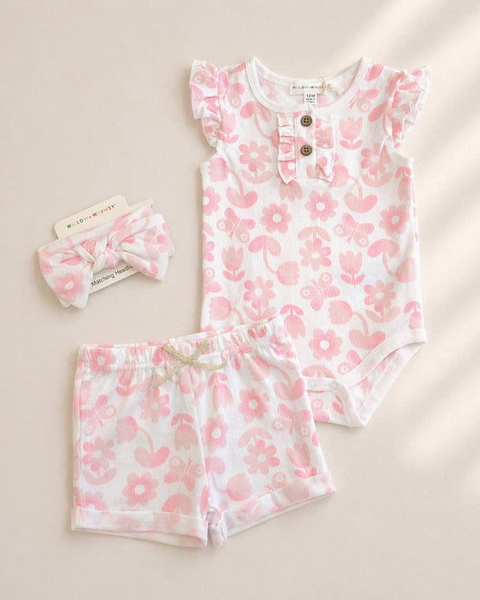 Baby outfit set with floral pattern on a beige background