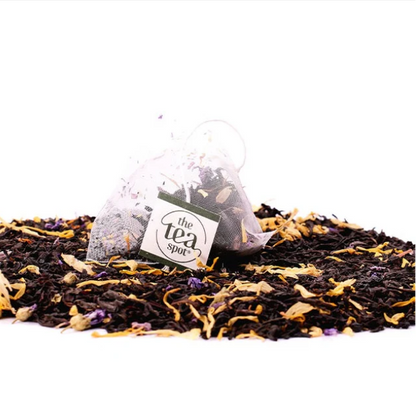Tea bags with floral elements on a white background, featuring 'the tea spot' brand.