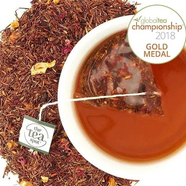Tea leaves, tea bag, and brewed tea with 'The Tea Spot' label and 'Global Tea Championship 2018 Gold Medal' badge.