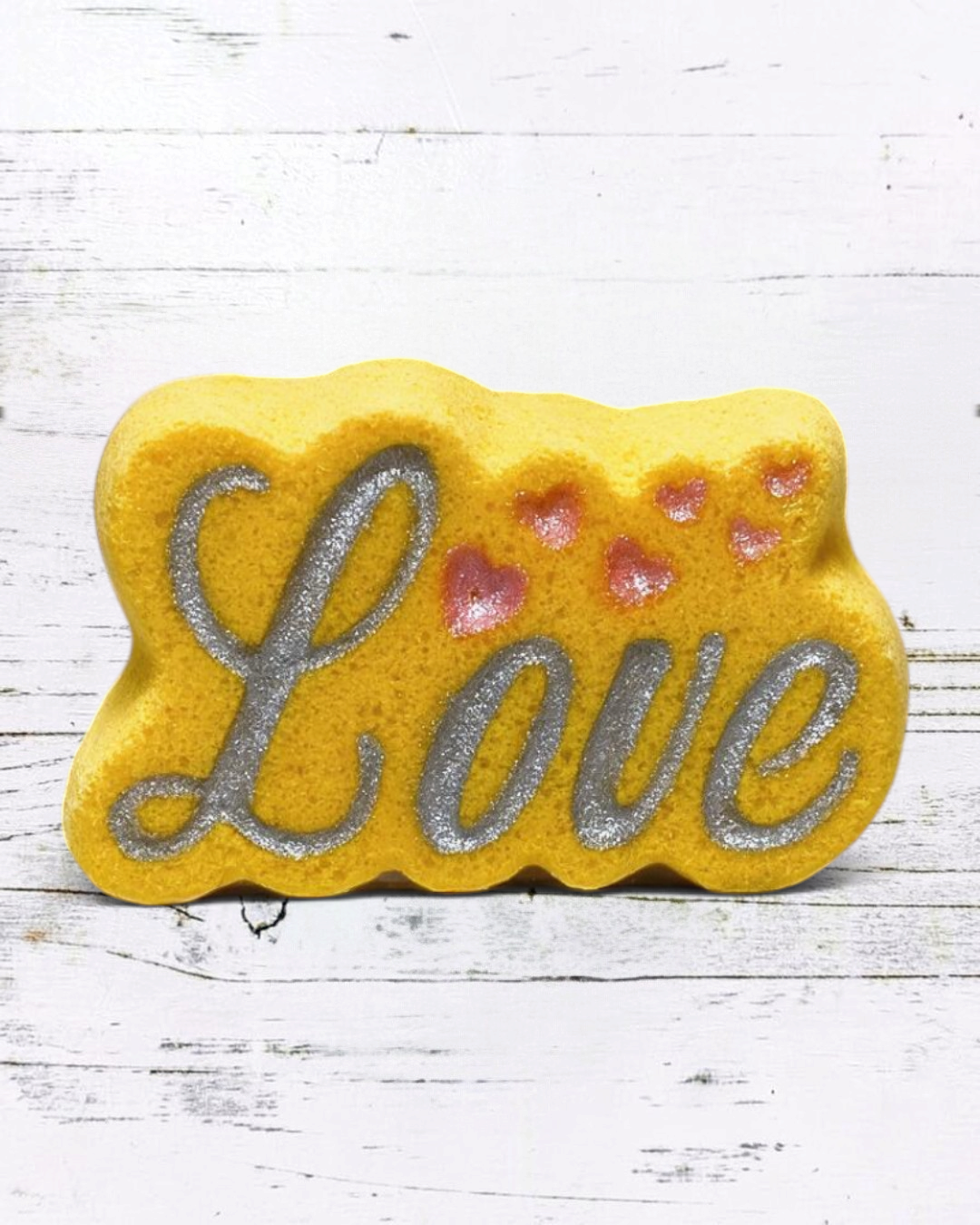 Calla Lily Cosmetics + CL kids yellow Love bath bomb with silver glitter lettering and pink heart accents