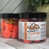 Two jars of our orange gumdrop shaped monkey farts bath bombs