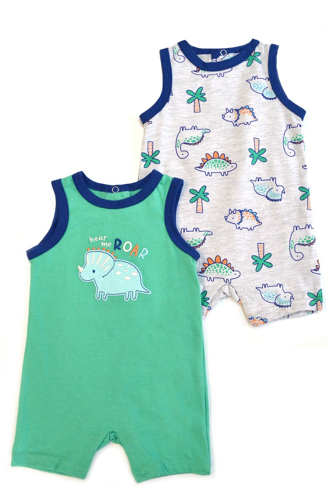 Two baby rompers with dinosaur prints on a white background
