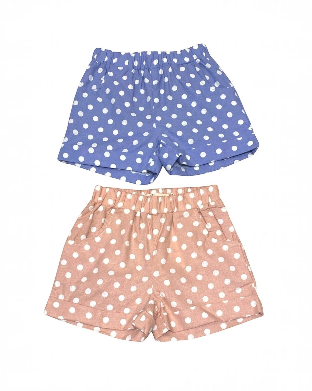 Two pairs of polka dot shorts, one blue and one pink, on a white background.