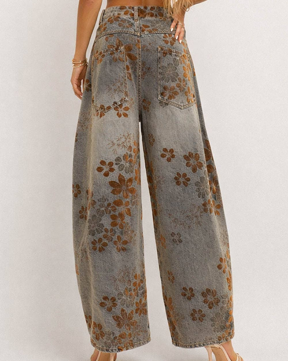 Floral-patterned wide-leg jeans on a plain background