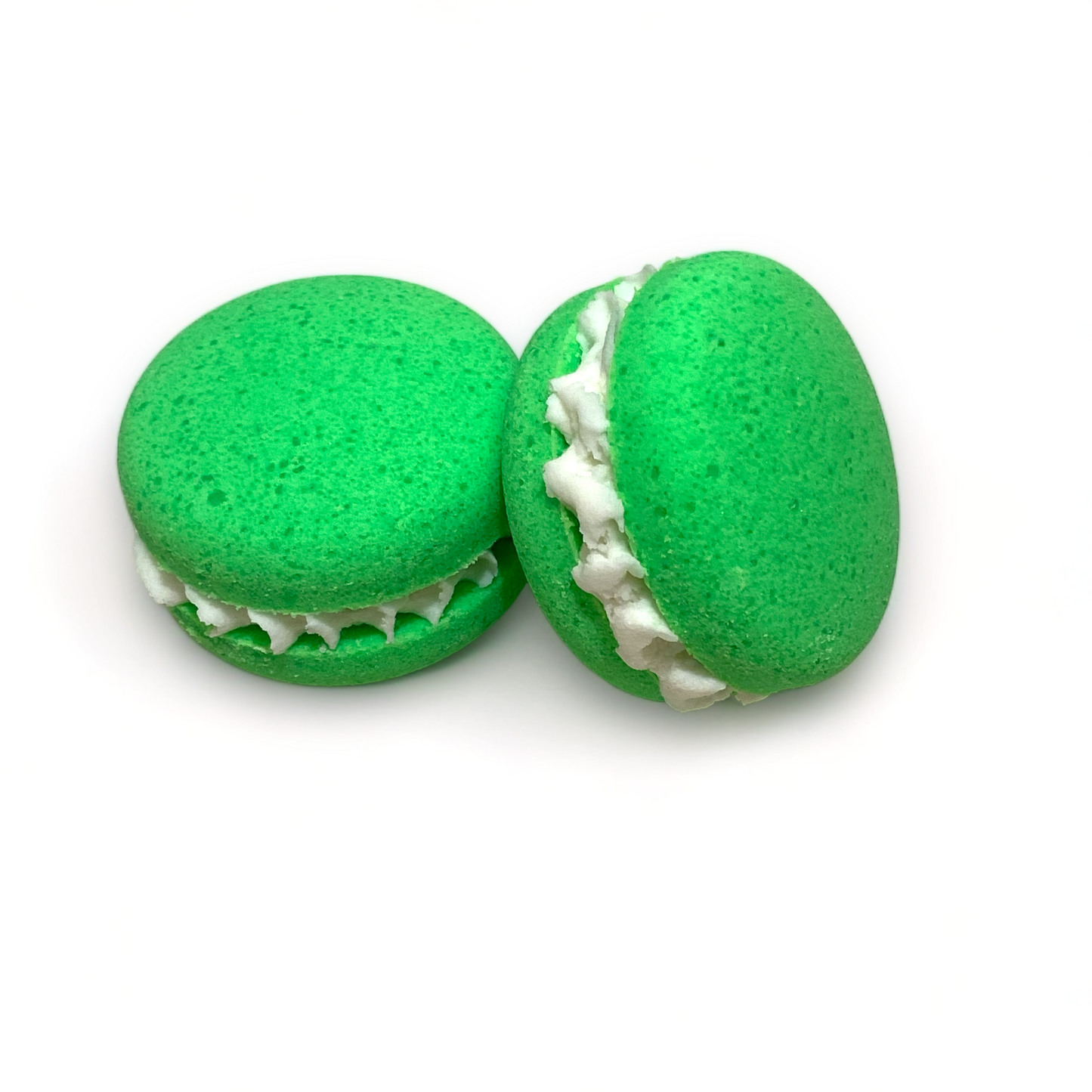 Two green dino burps bath cookies against a white background