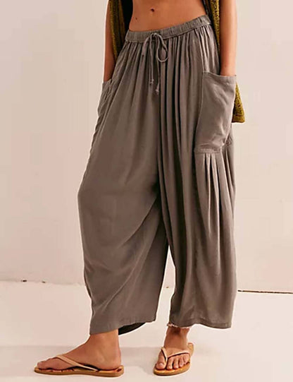 Gray wide-leg pants worn by a person on a plain background