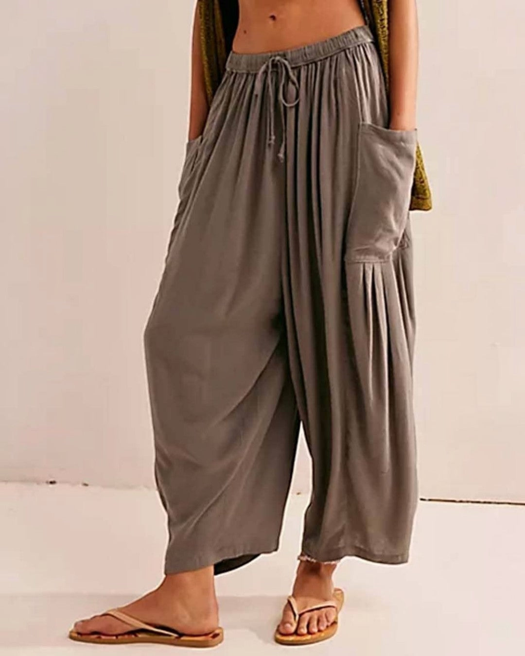 Gray wide-leg pants worn by a person on a plain background