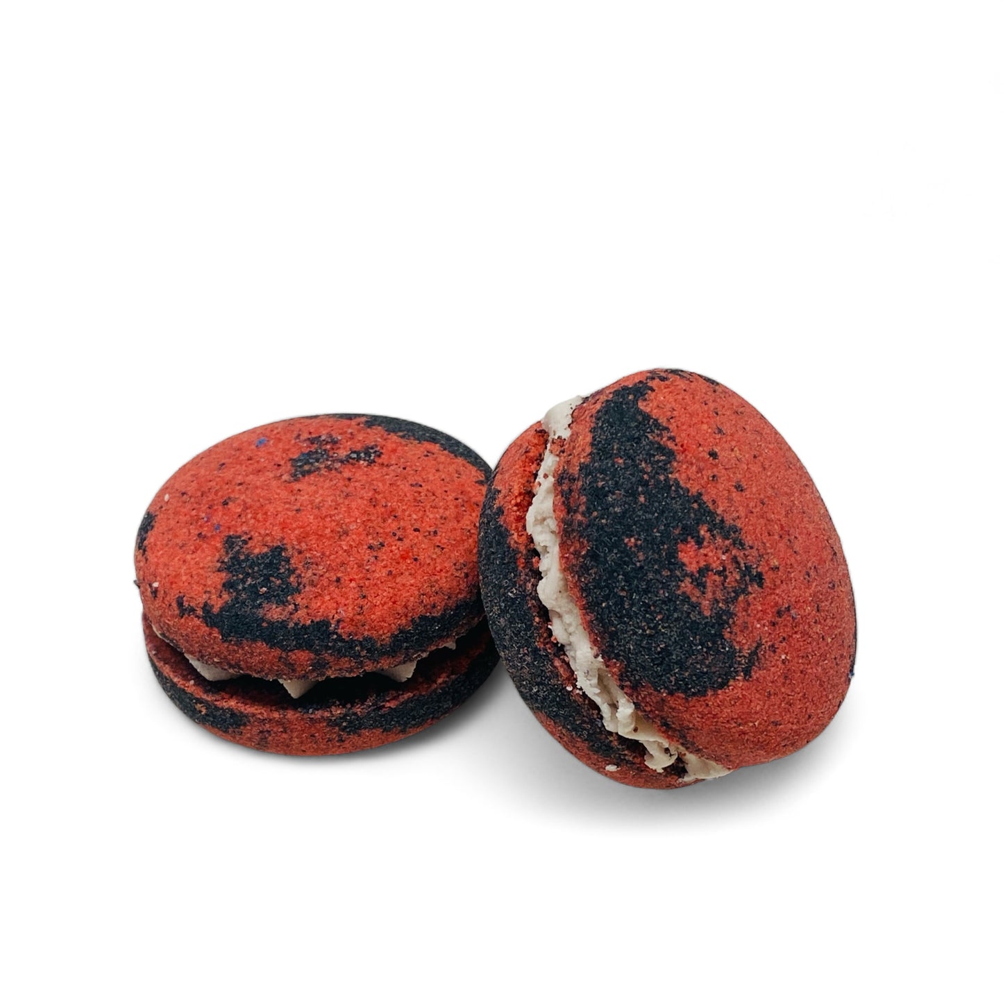 Two red and black dragons blood bath cookies against a white background