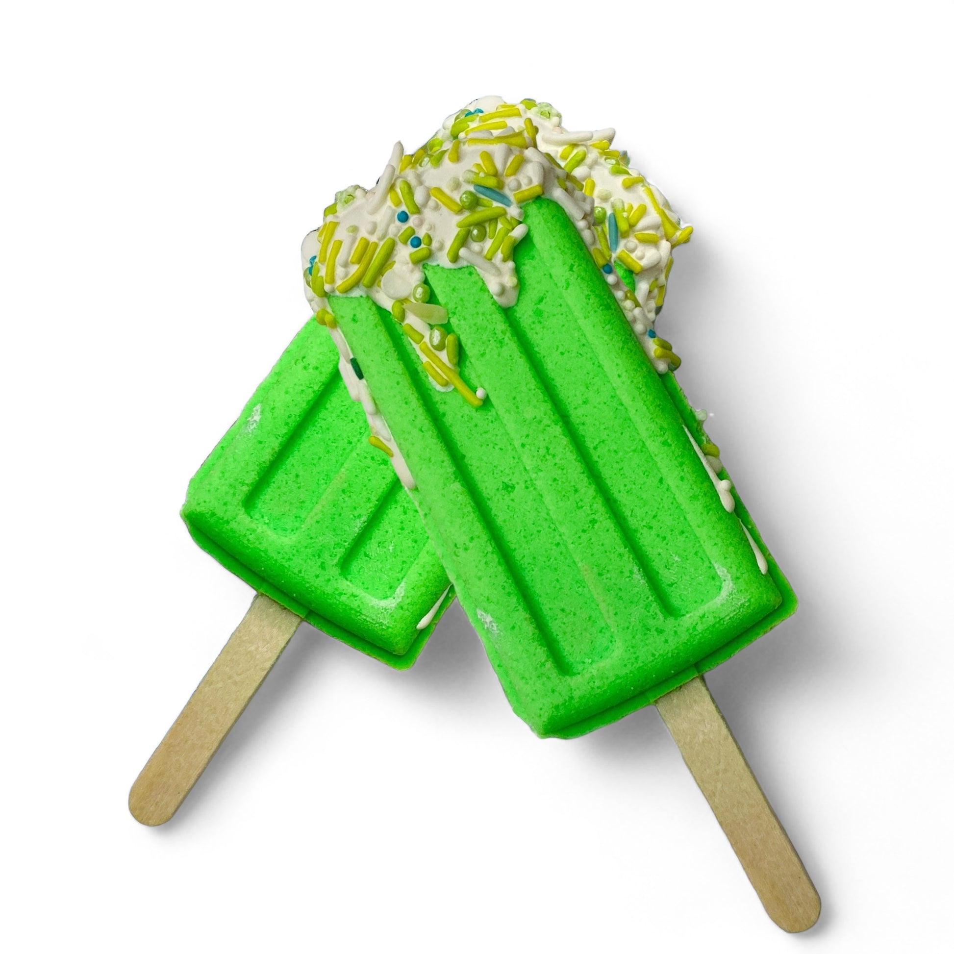 Two popsicle bath bomb - green against a white background