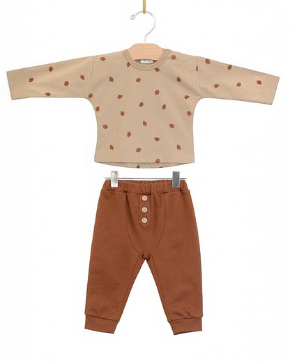 Children's outfit with beige top and brown pants on a white background