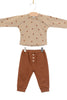 Children's outfit with beige top and brown pants on a white background